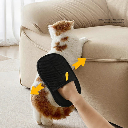 Hand using the glove to lift loose fur from a sofa