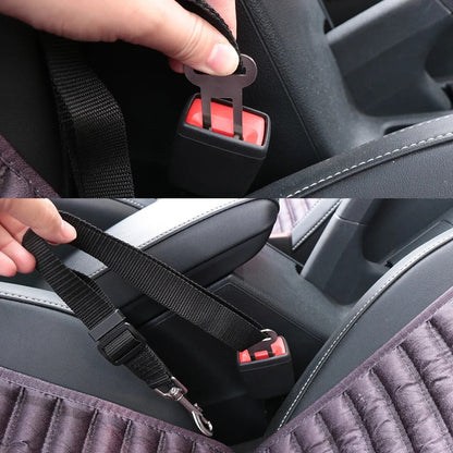 Close-up of a hand inserting the tether's metal tab into a vehicle seat-belt receptacle