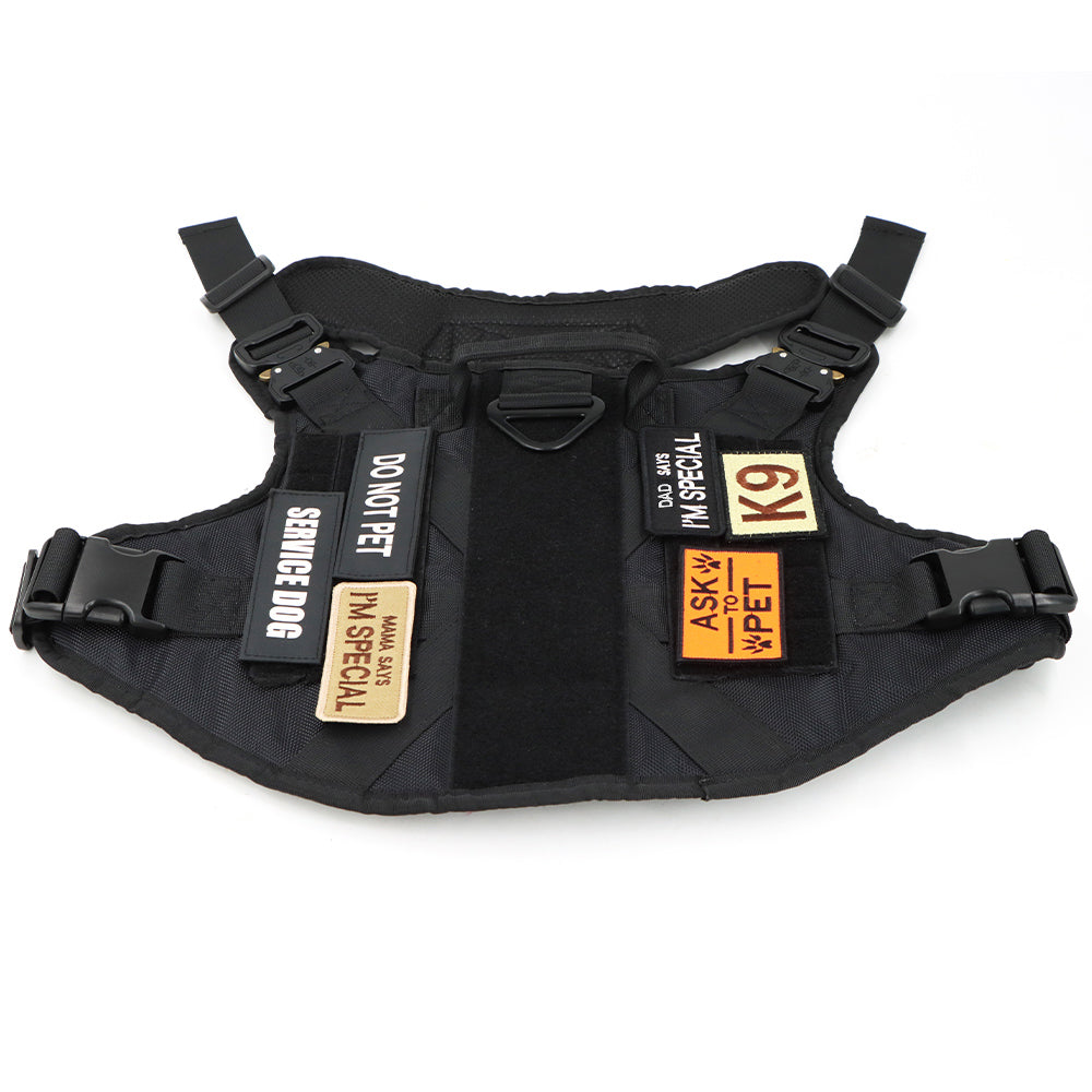 Black dog harness with multiple service patches attached