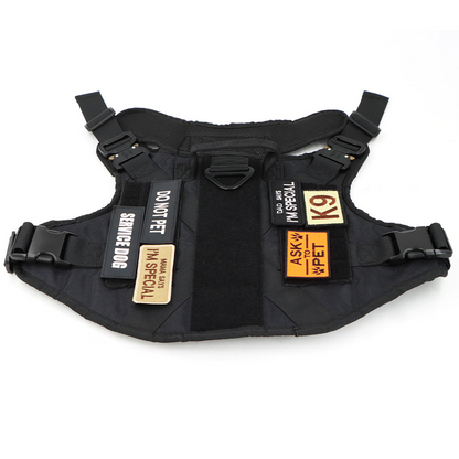 Black dog harness with multiple service patches attached