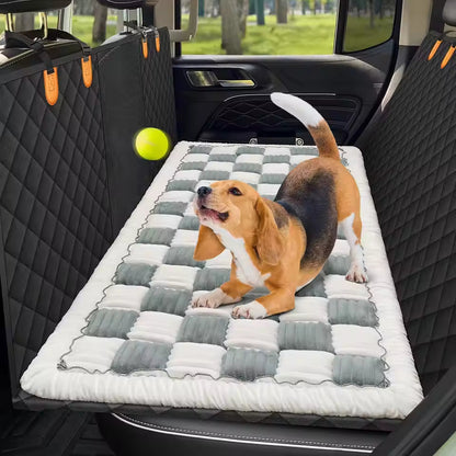 Dog resting on a gray checkered plush bed