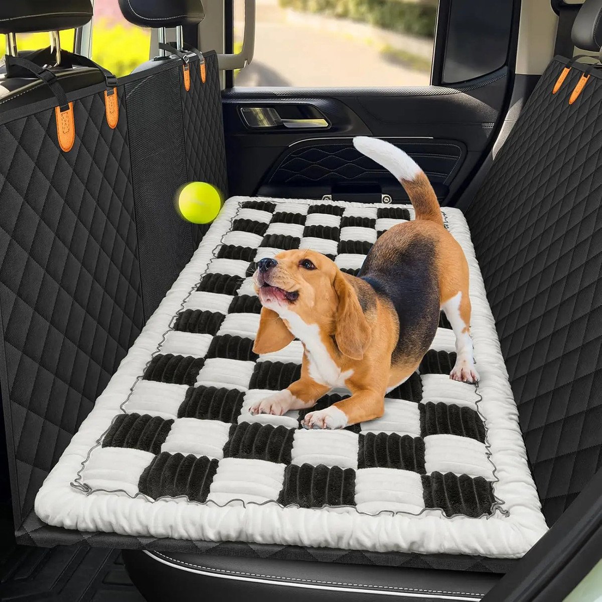 Dog sitting on the plush bed inside a vehicle