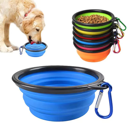 Dog drinking from a blue collapsible bowl beside stacked bowls